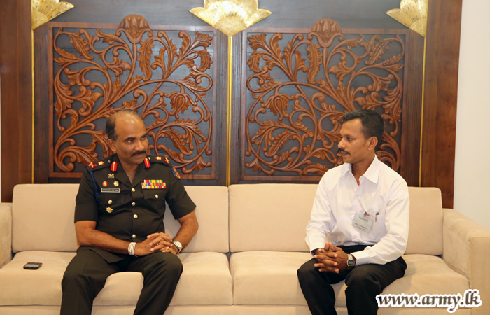 Commander Congratulates Civil Employee on His Exam Achievement