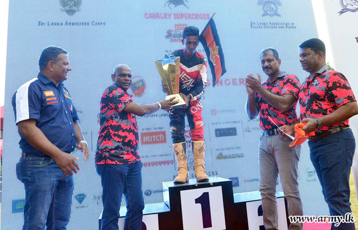 Signal Corps Rider in ‘Cavalry Supercross’ Carries ‘Best Rider Trophy’  