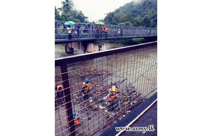 Army Troops Clear Passage for Gushing Water under Two Bridges  