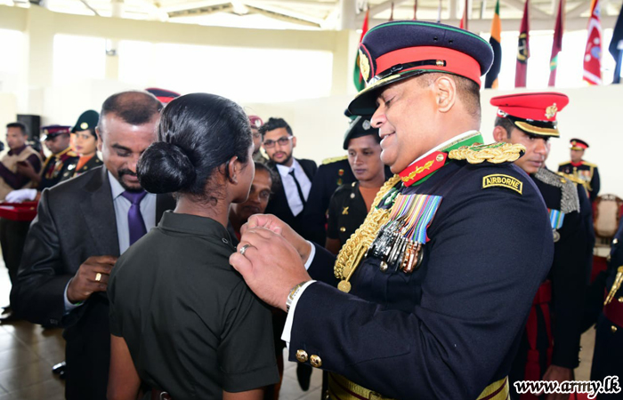 Commander with Parents Pins Pips on SLMA's New Graduates