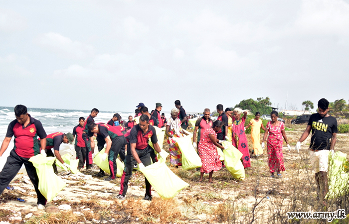 Troops with Sailors and Civilians Clean Pooneryn Beach 