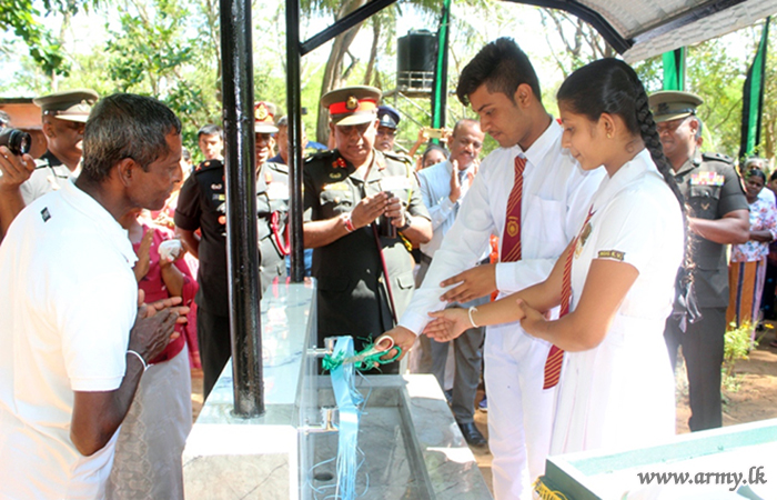 Army Troops thru Sponsors Install Water Purification Unit for Civilians