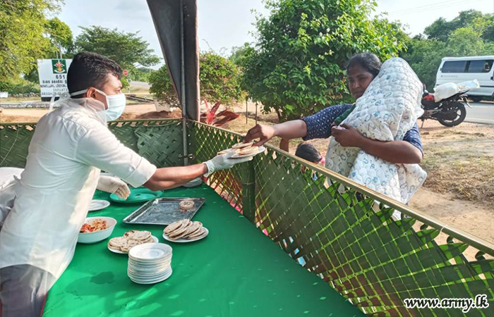 651 Infantry Brigade Troops on ‘Poson’ Day Serve Flat Bread to Civilians