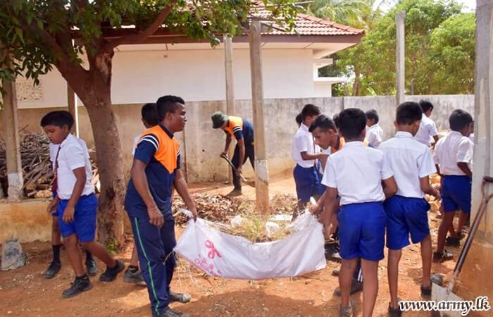 4 SLSR Troops Join Students to Clean School Compound 
