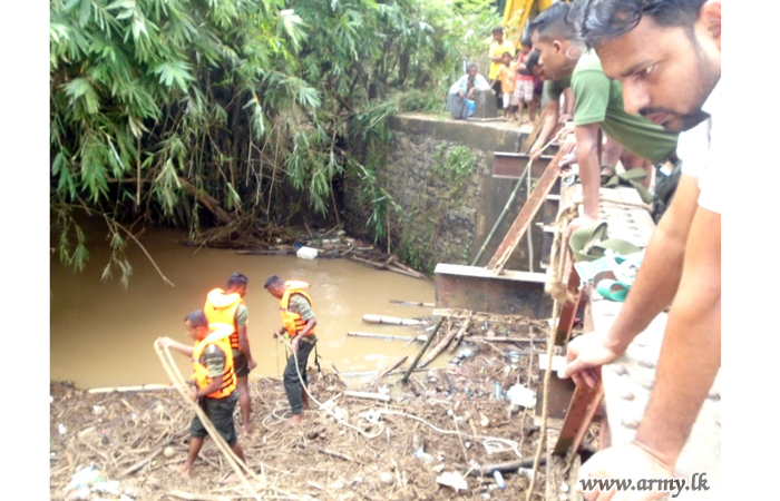 Troops Restore Smooth Flow of Rainy Water   